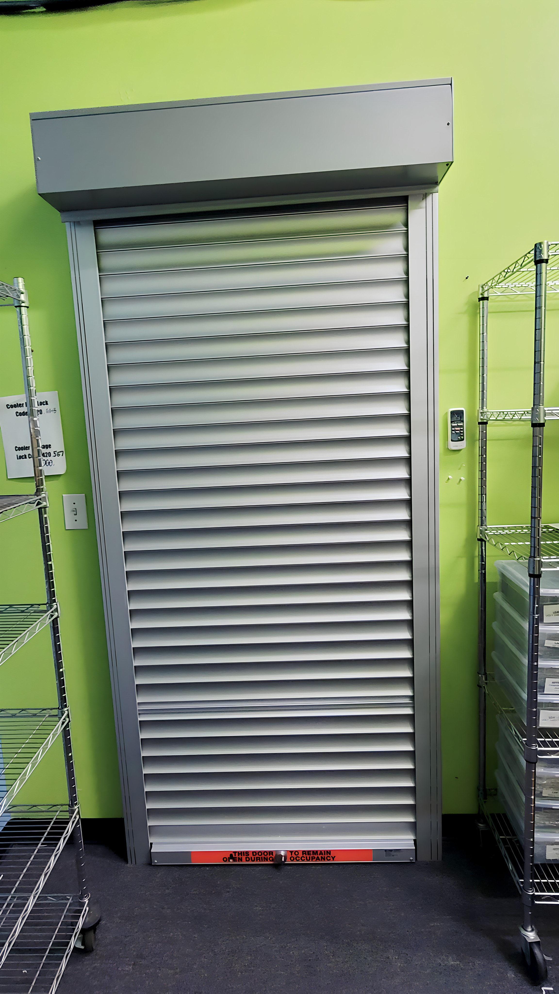 aluminum rolling shutter protecting the door of an inventory room at a cannabis dispensary