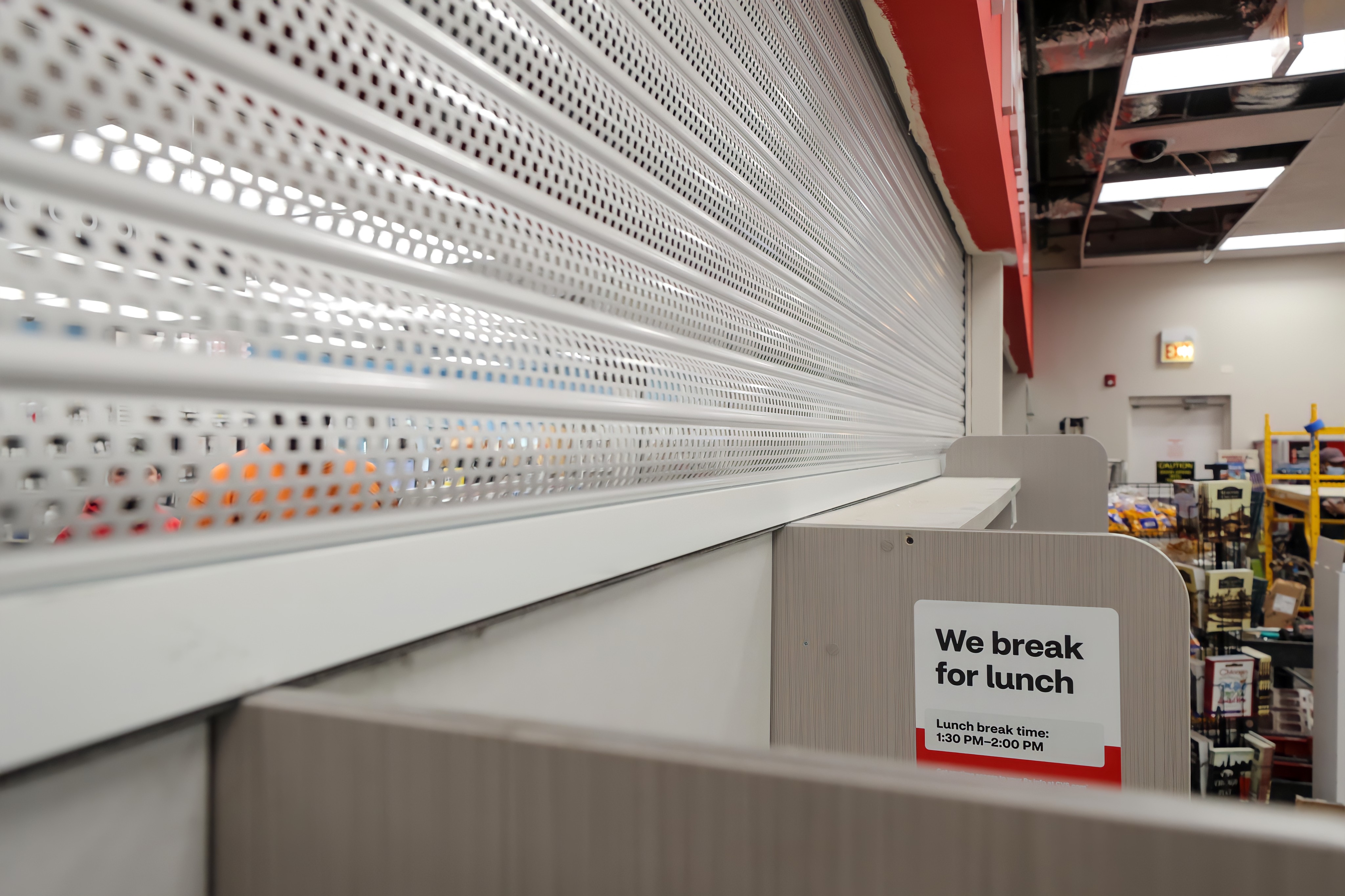 white perforated security shutters protect a pharmacy counter