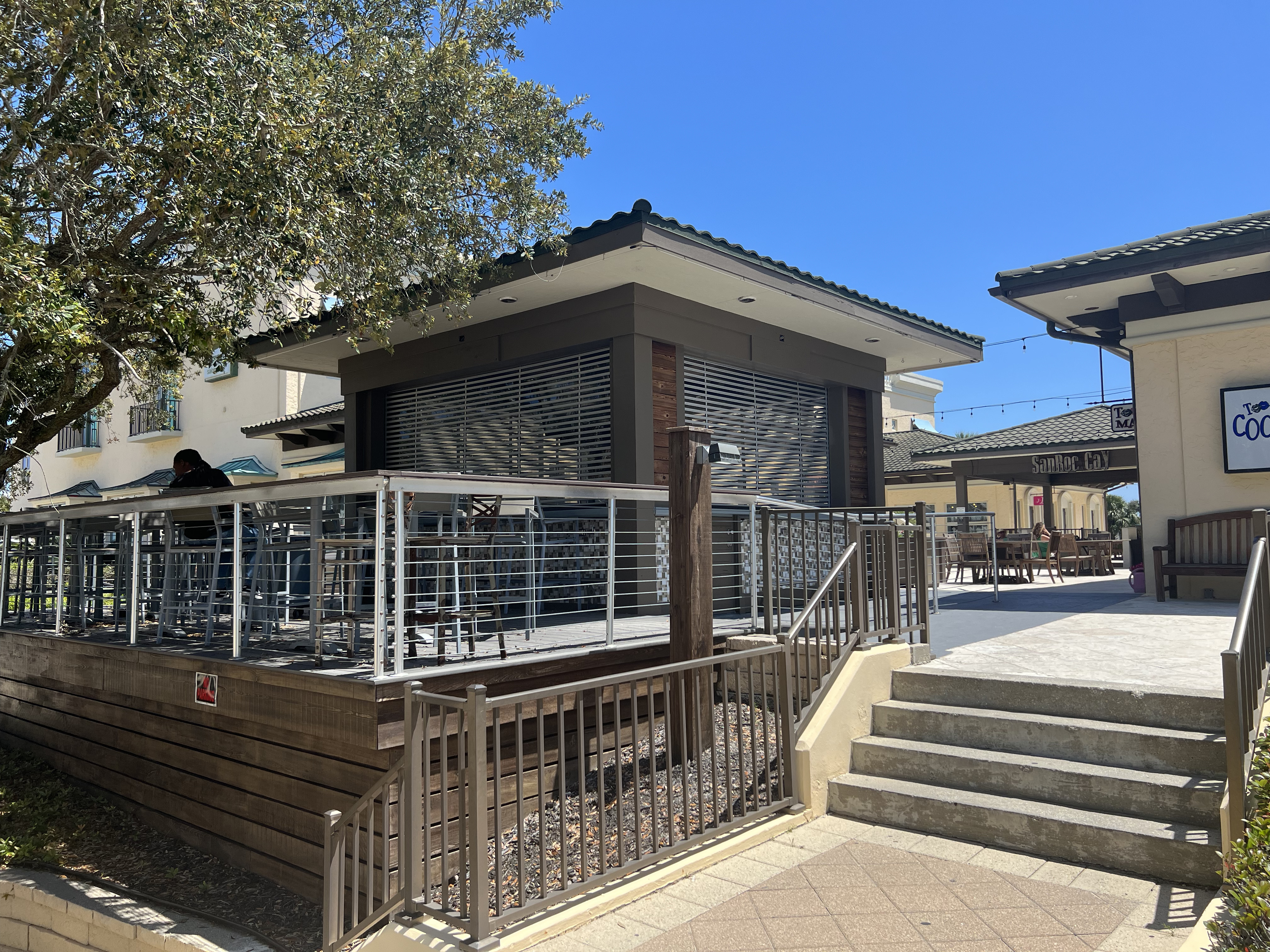 clear shutters protect an outdoor bar