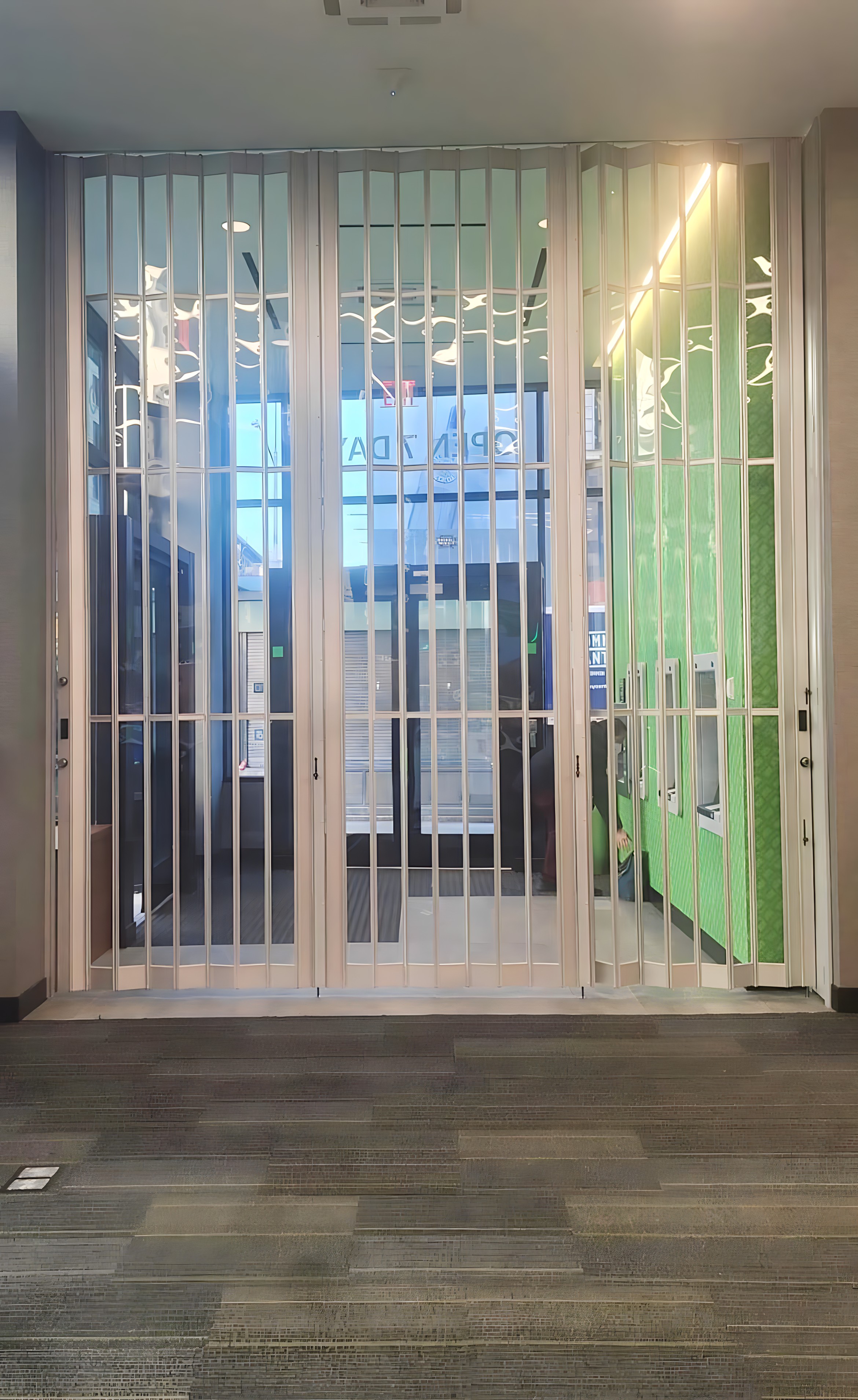 a bank atm vestibule protected by a side-folding grille