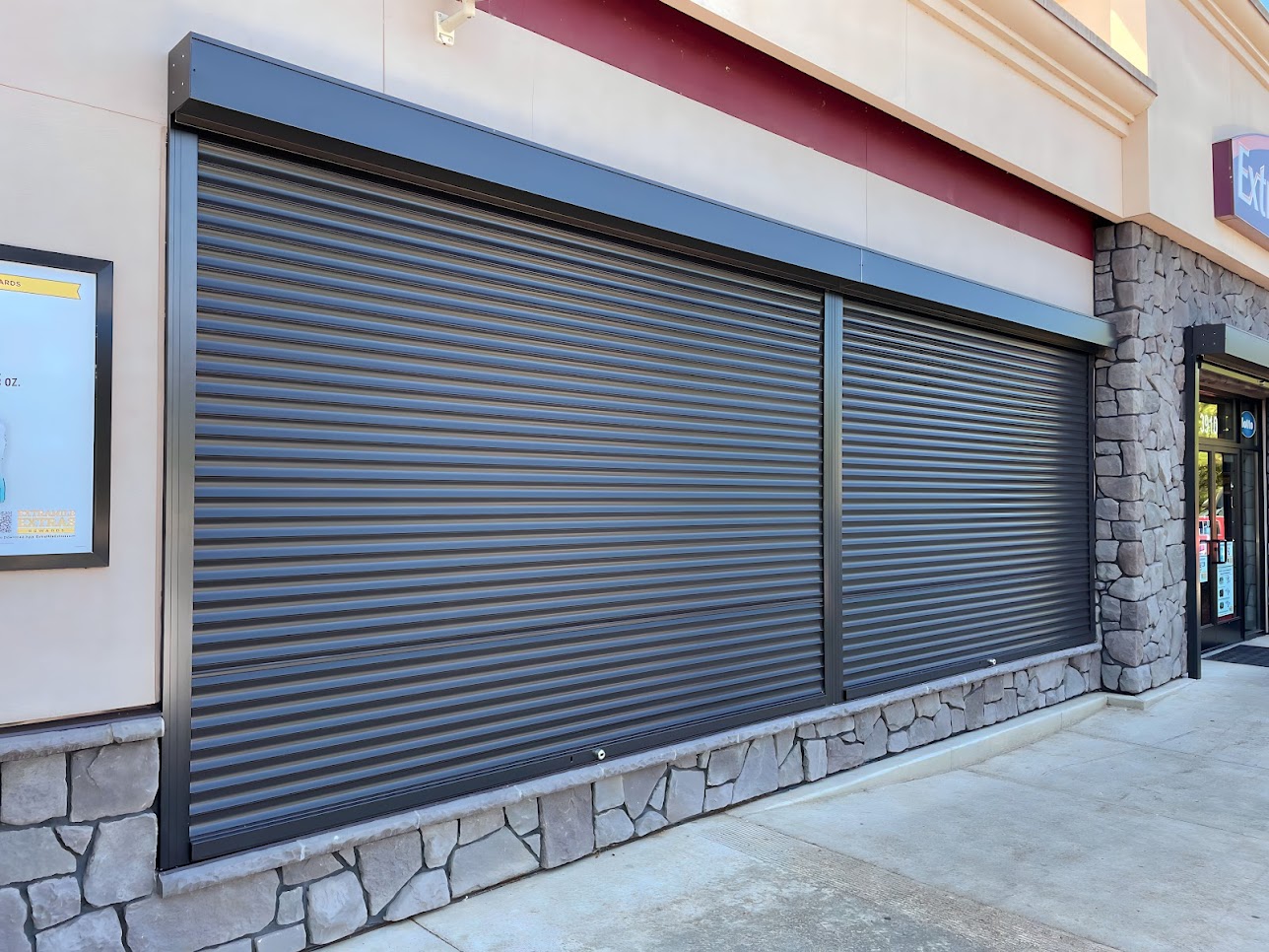 Bronze security shutters protecting a convenient store in Portland, OR