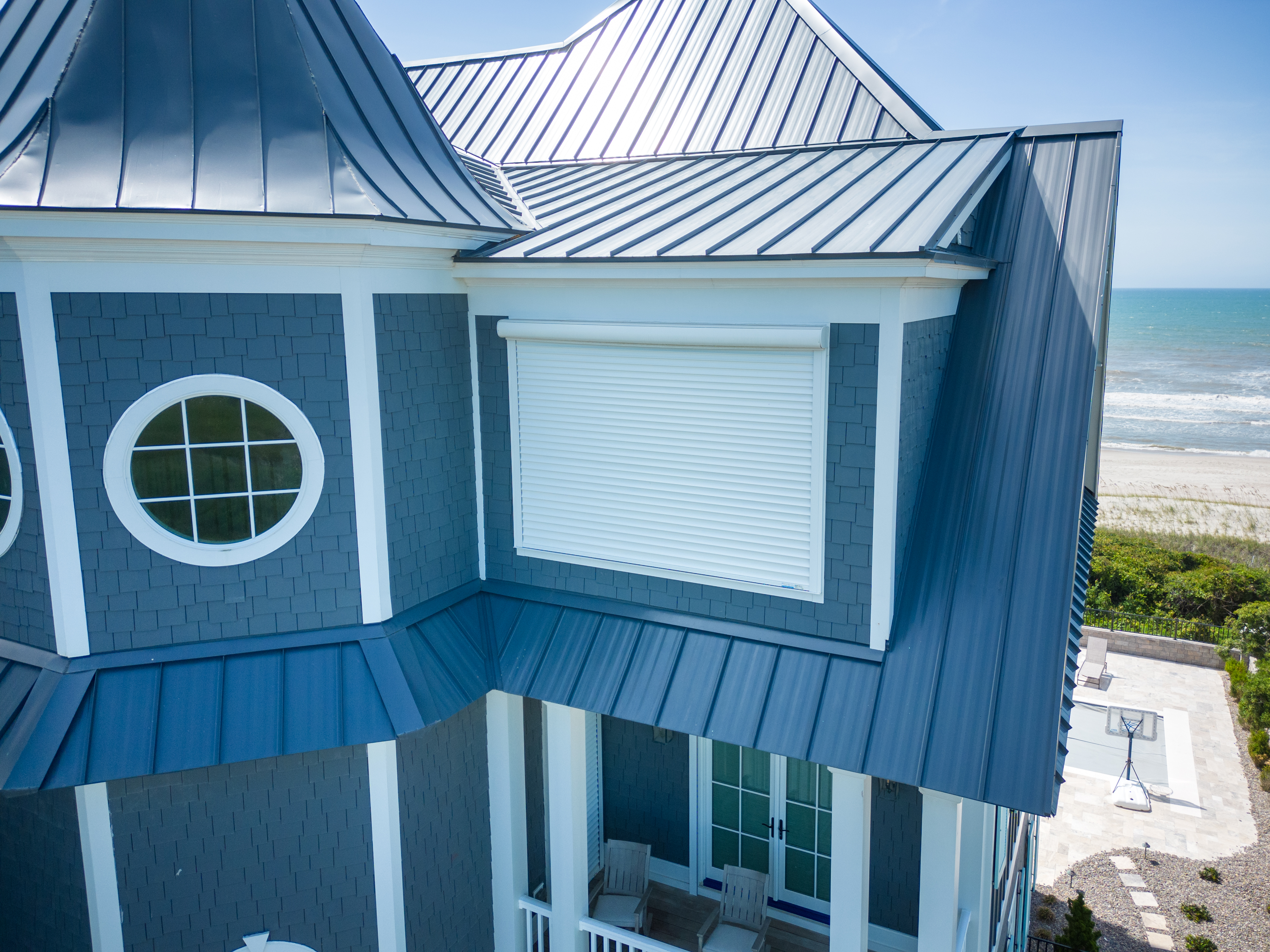 Security shutters installed on the windows of a beach house. The shutters are closed for protection to the property.