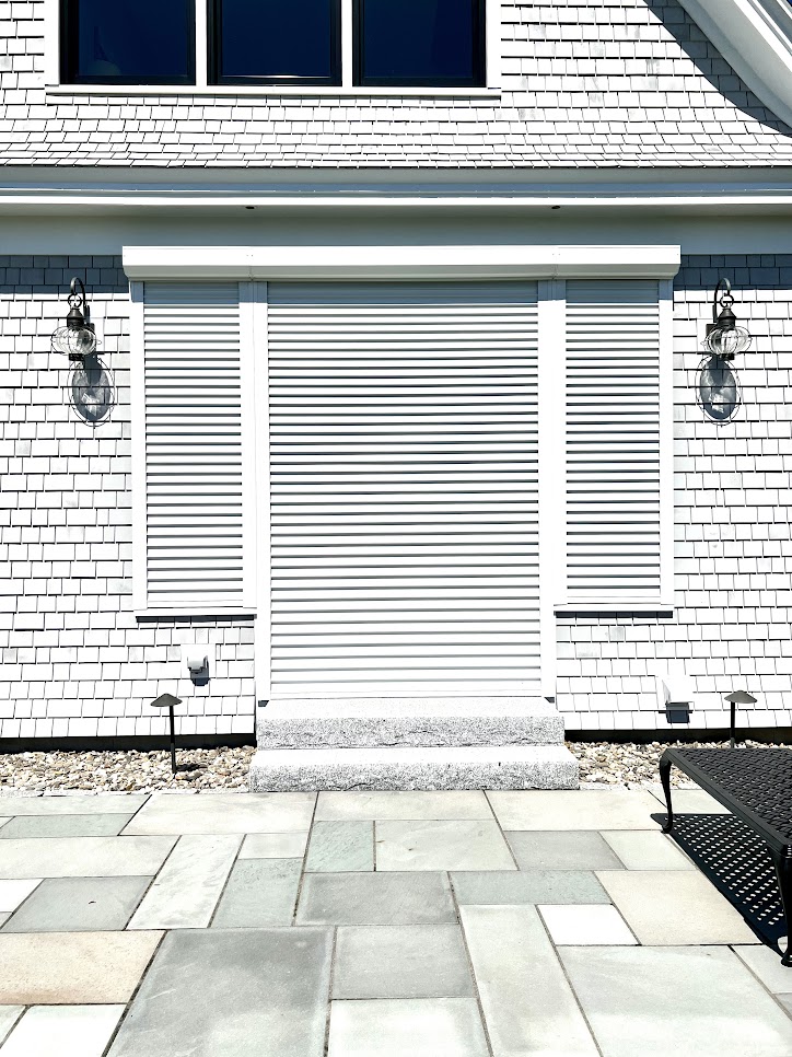 hurricane shutters on white residential house