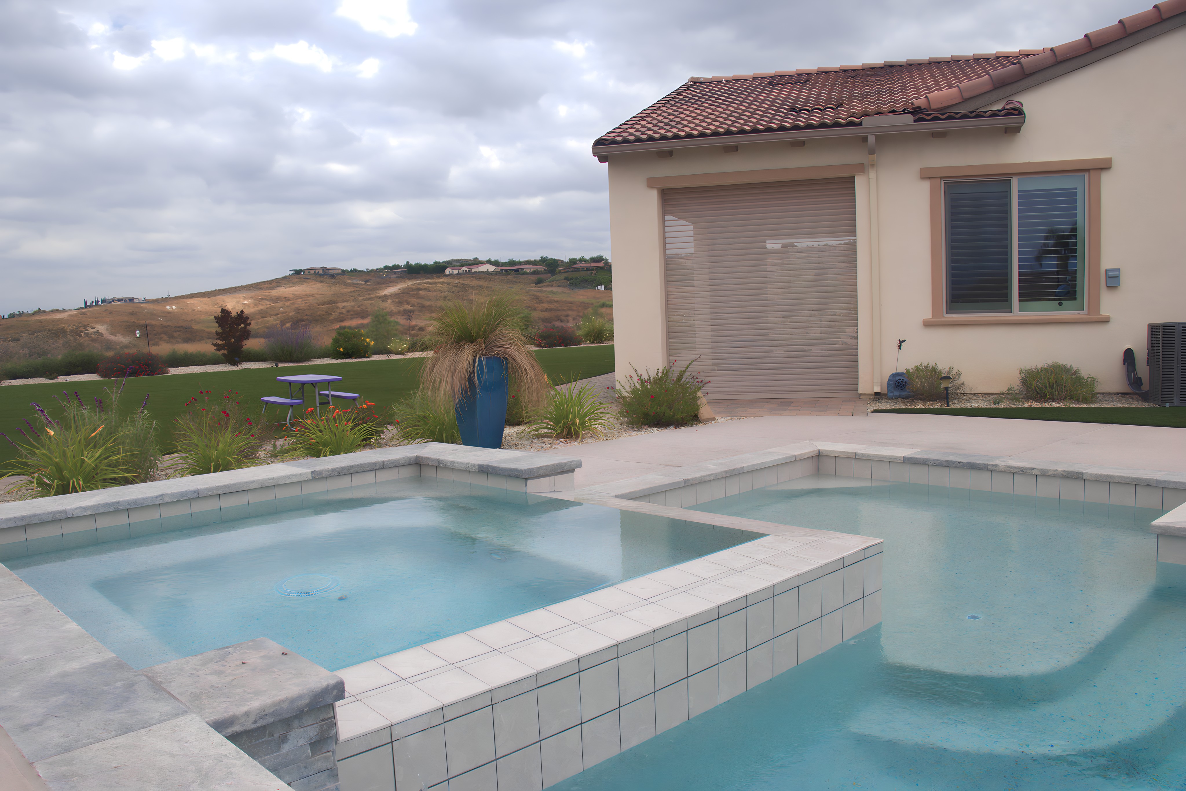 southern california home with Qompact shutters with a pool