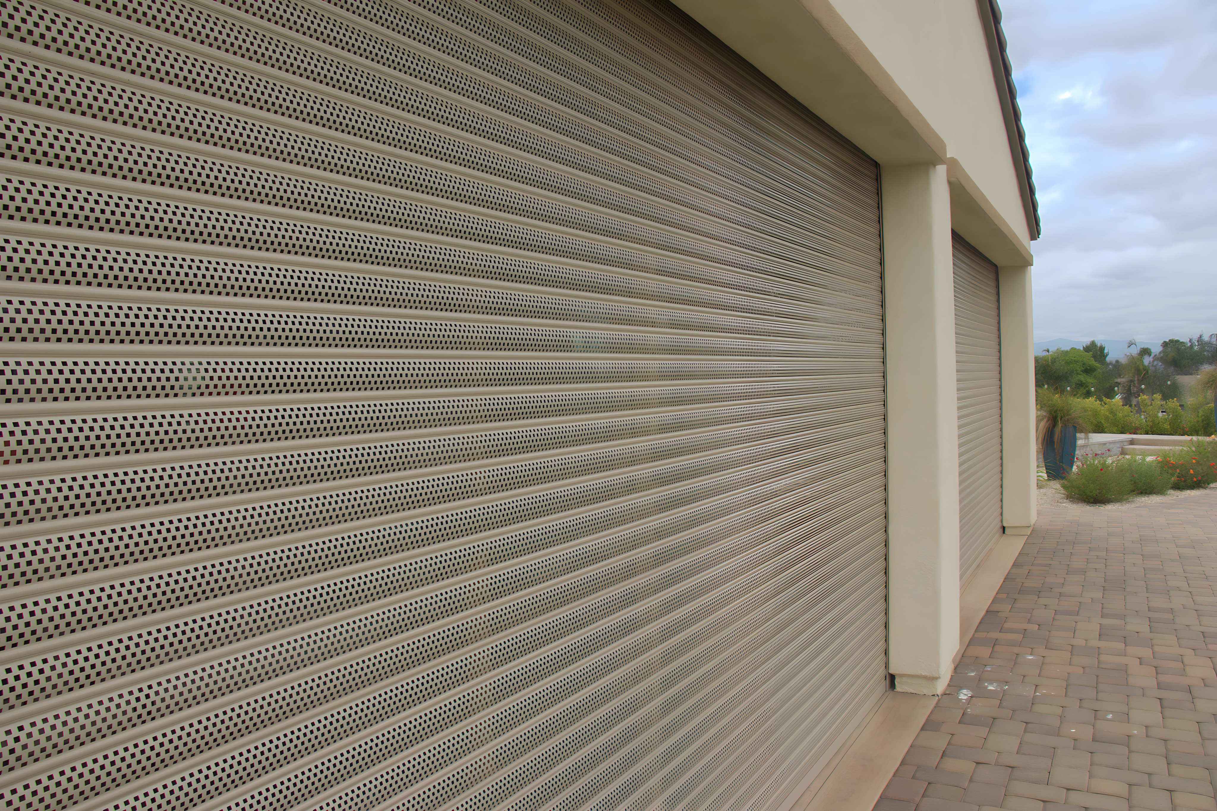 tan security shutters on a house