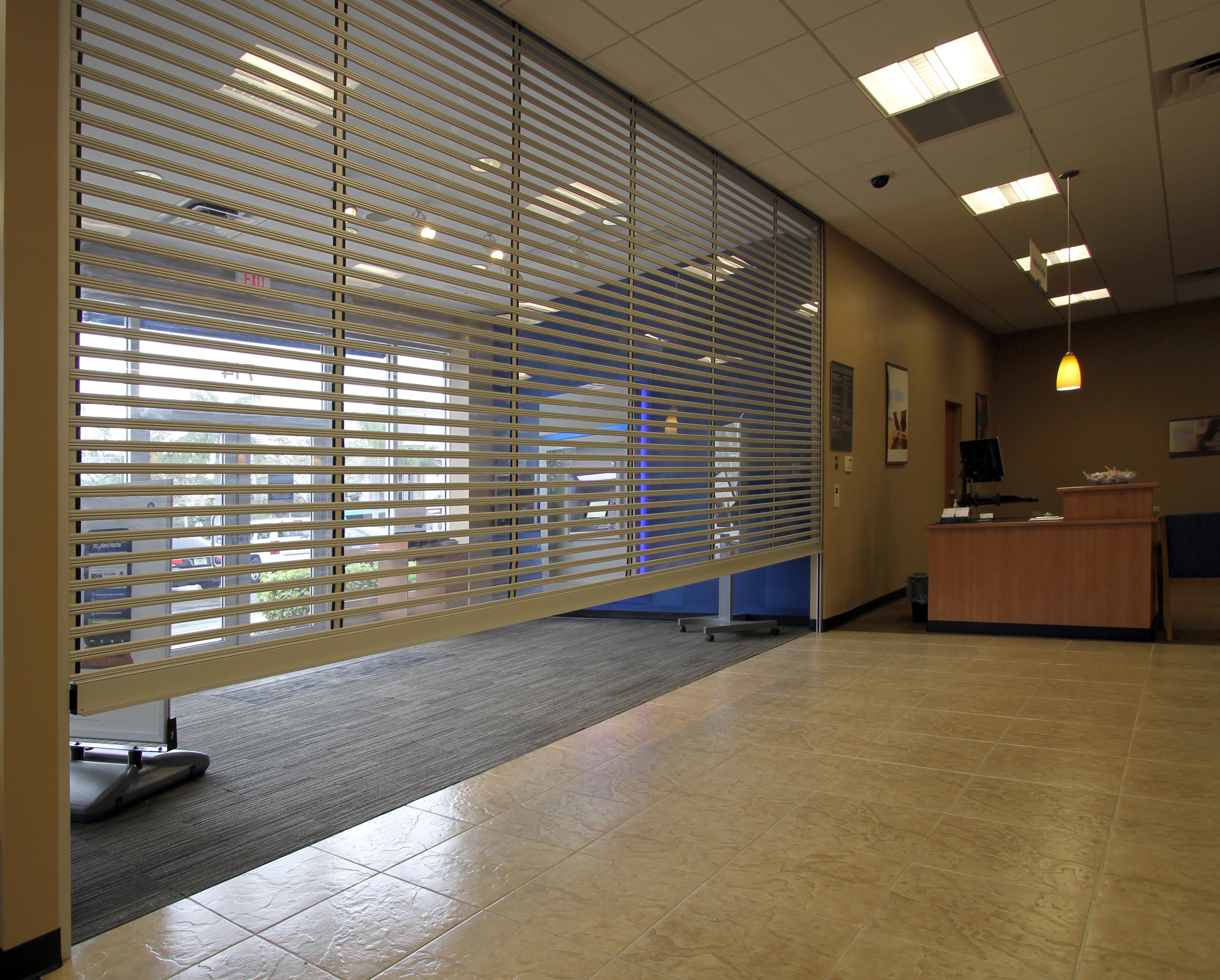 a clear polycarbonate shutter protects an atm vestibule