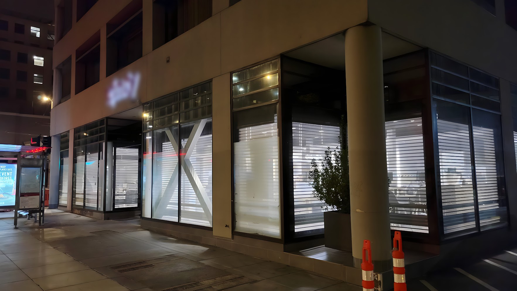 aluminum rolling shutters with perforted slats protects an Xfinity store in downtown Chicago