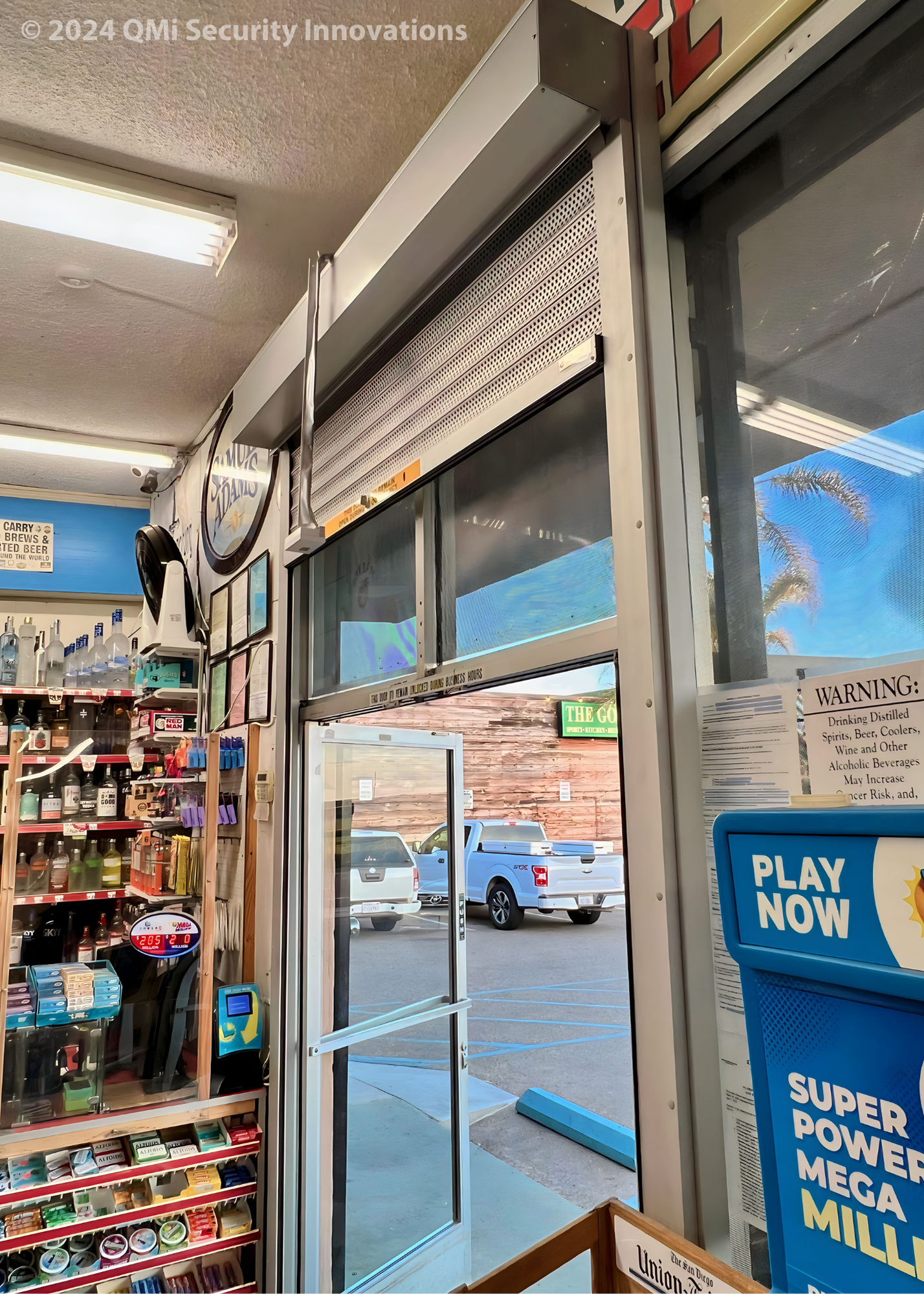 a convenience store in California uses aluminum security shutters to protect its storefront door and windows.