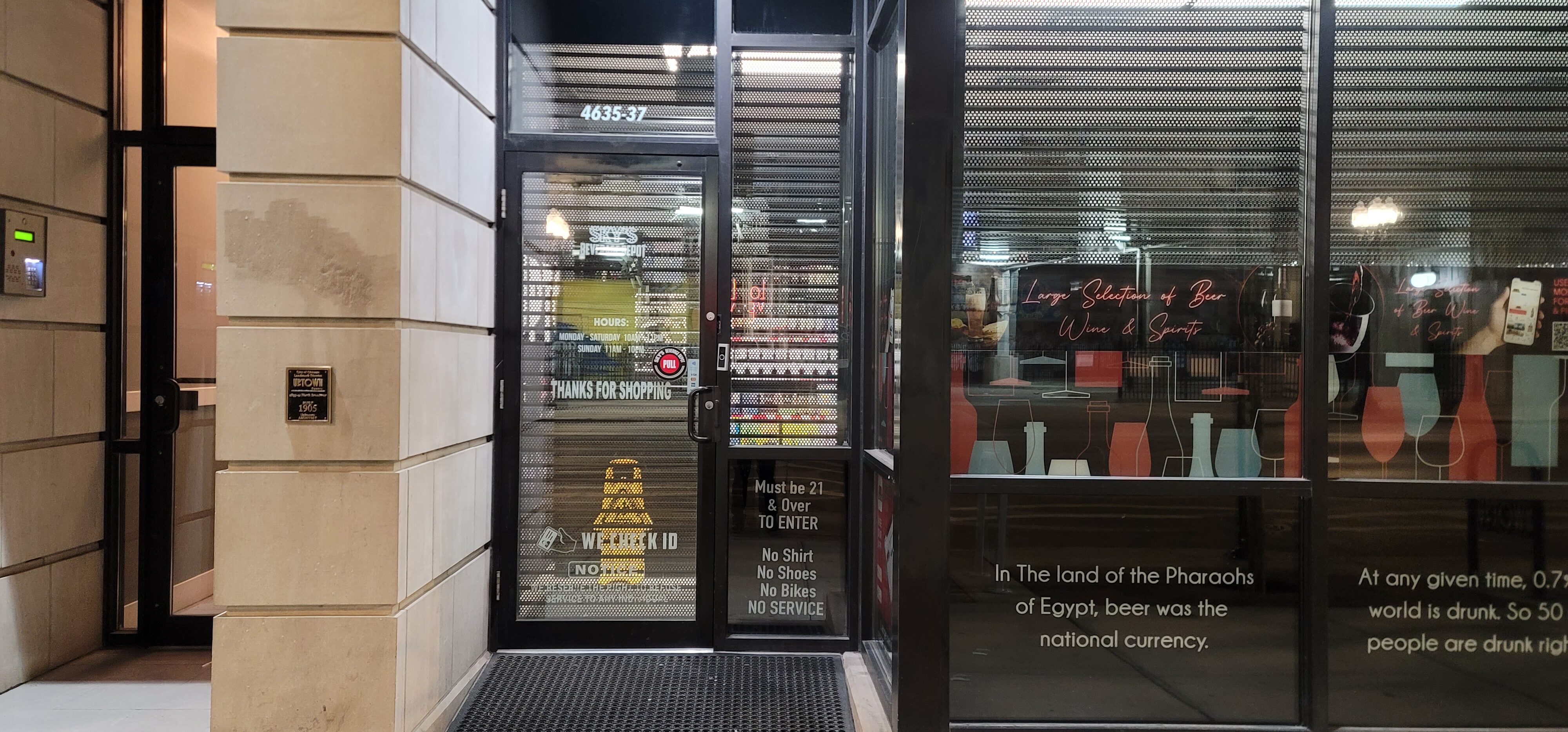 A liquor store uses perforated storefront shutters to protect from forced entry