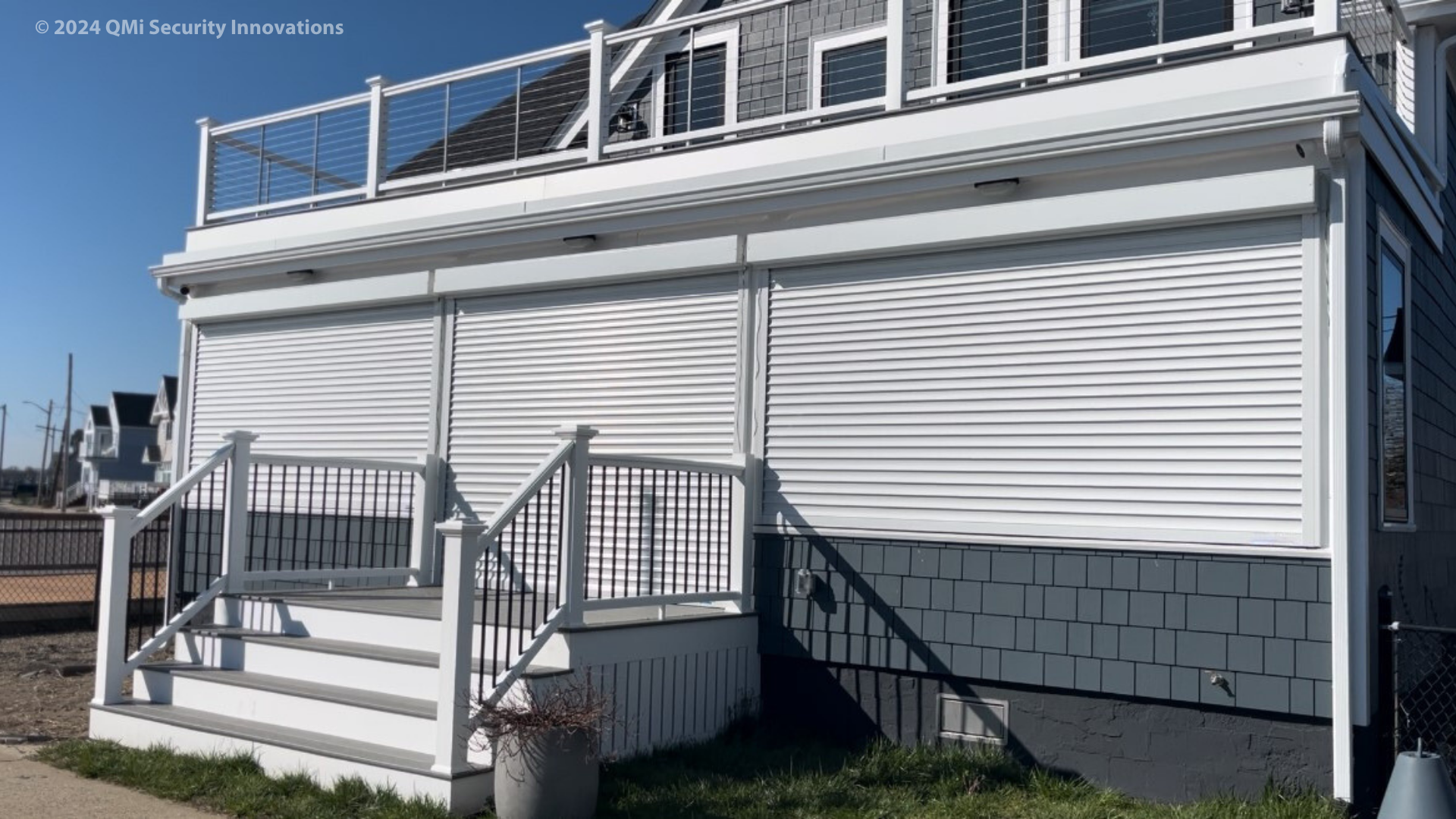 Qompact hurricane shutters protect the windows and doors of an ocean front property in Maine.